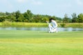 Golfer sport course golf ball fairway.ÃÂ  People lifestyle man  putting golf ball on the green grass. Royalty Free Stock Photo